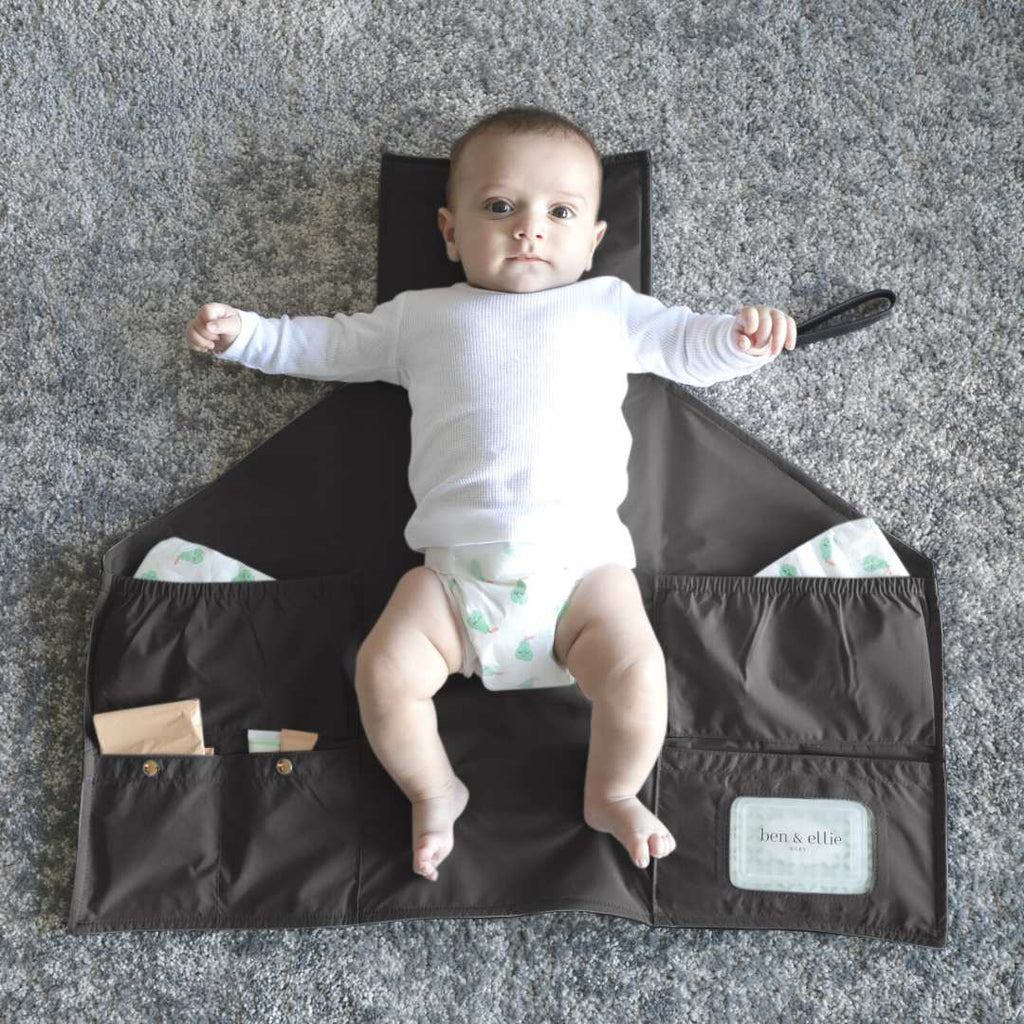 Baby Laying on Open Black Vegan Leather Nappy Change Clutch | Ben & Ellie Baby